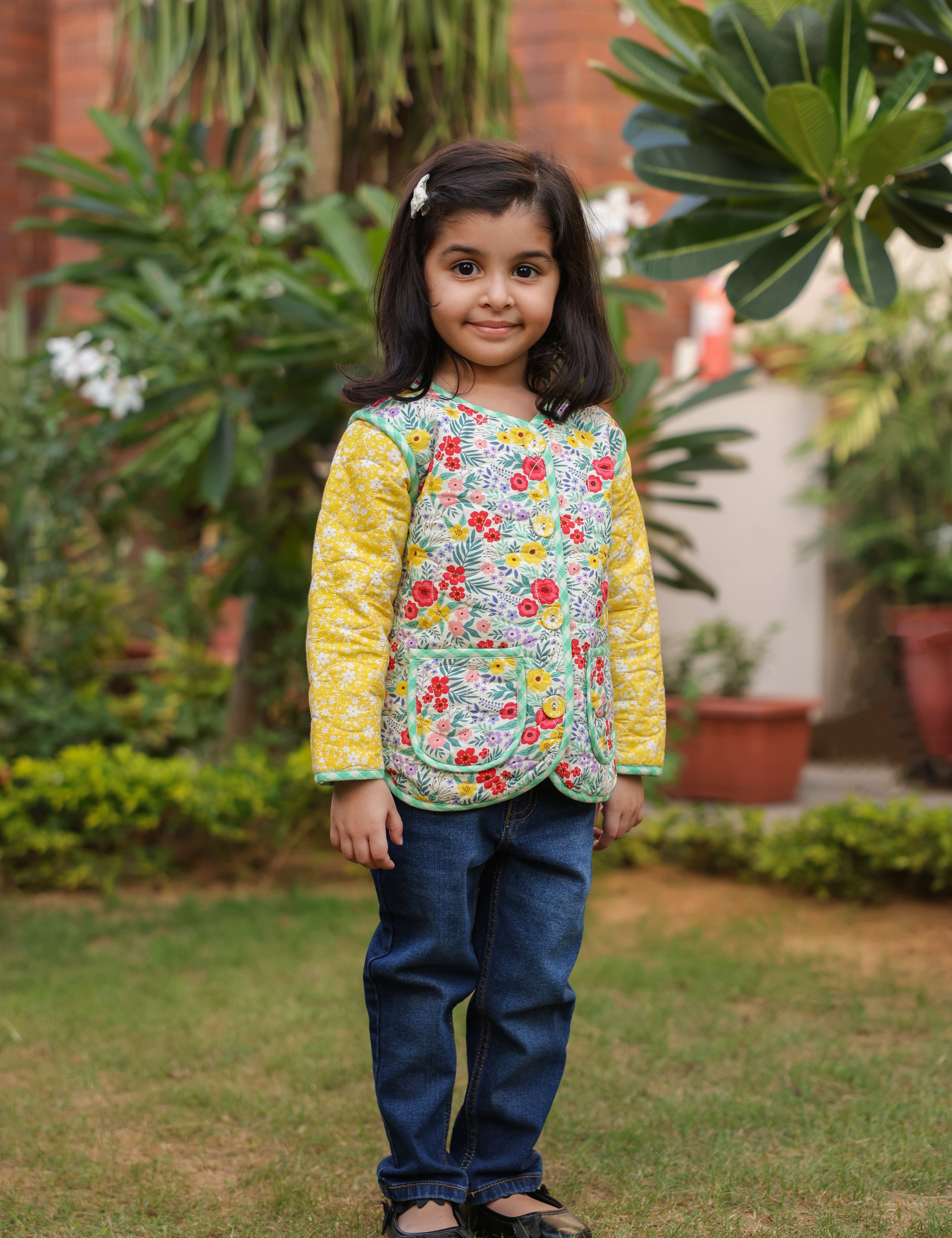 Girl wearing floral cotton quilted jacket with jeans